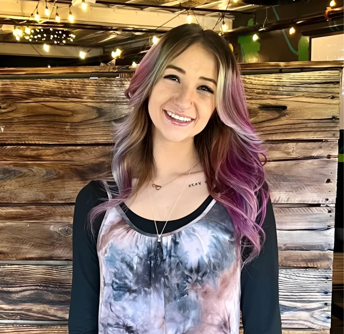 Young woman in front of wooden wall