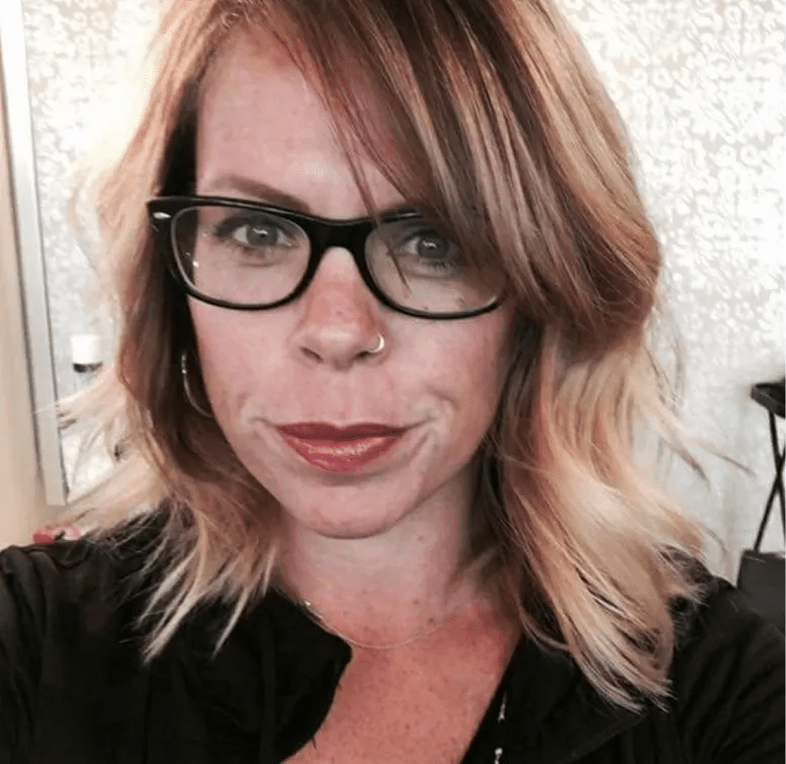 Woman wearing glasses, light brown hair