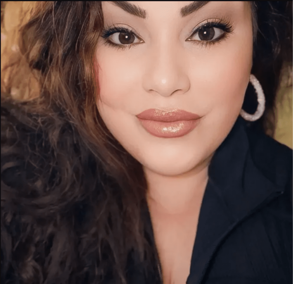 Woman with wavy hair and hoop earrings