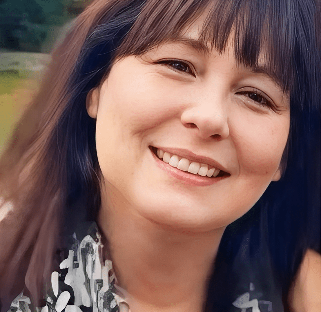 Smiling woman with dark hair outdoors